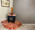 Small fireplace with pink salt facing against a gray wall