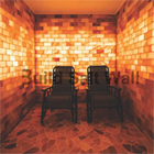 Illuminated Himalayan Salt Room with Backlit Salt Bricks and Reclining Therapy Chairs