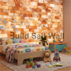 Warm Backlit Himalayan Pink Salt Brick Accent Wall in Cozy Kids Bedroom